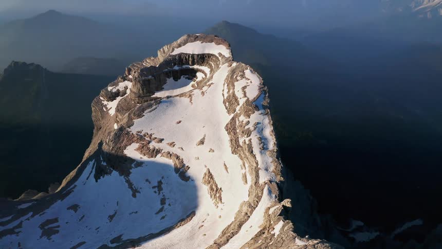 Sunlight is shining on snowy mountain tops