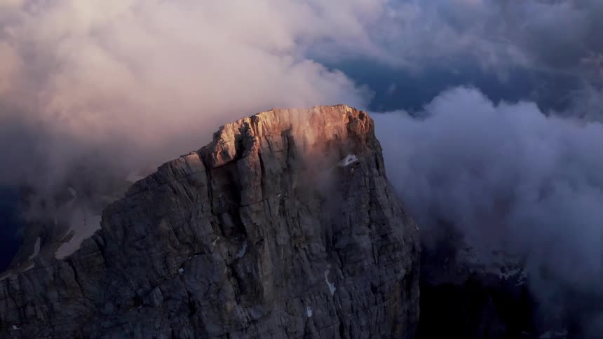 Aerial view of a mountain at dusk is displayed