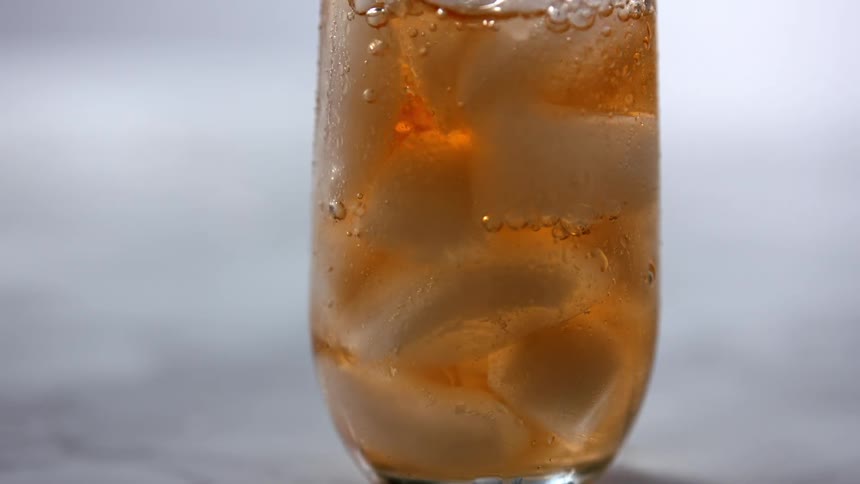 A beverage is being poured into a cup