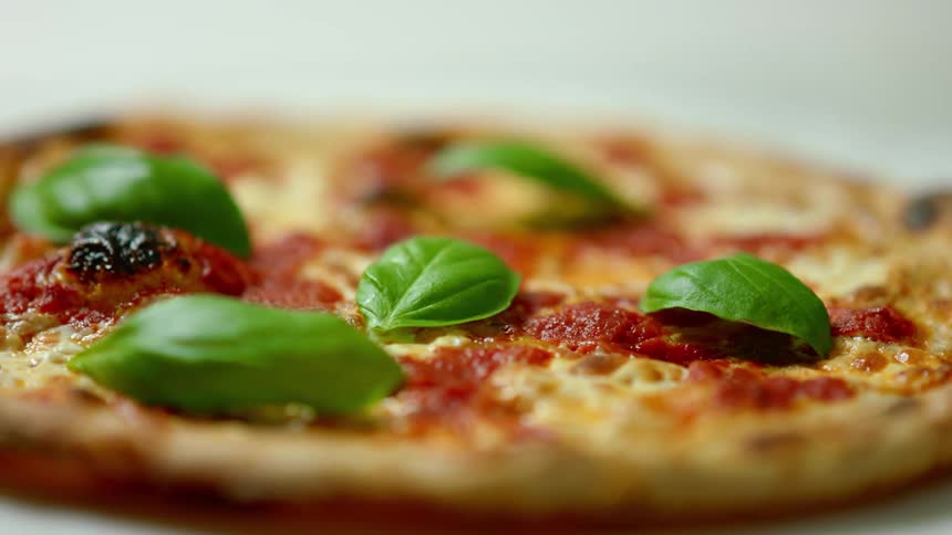 A pizza is displayed on a counter
