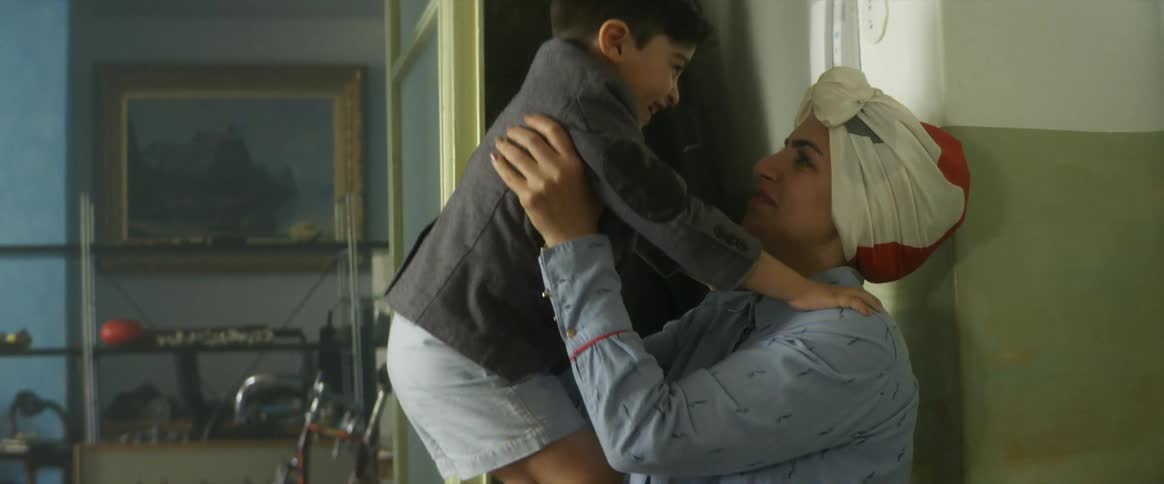 A young boy runs into a home and into his mothers arms