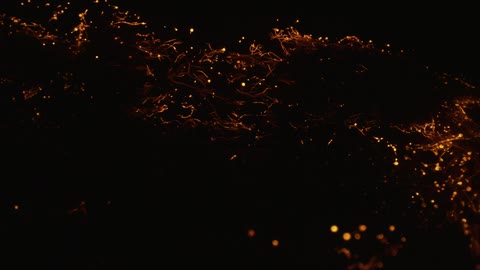 Low burning embers burn and float up and away causing shadows where cool