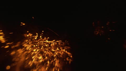 Orange strings of light bouncing in the dark