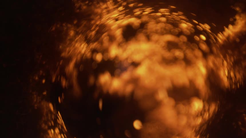 Small golden circles move among clumped fibers as the whole shakes
