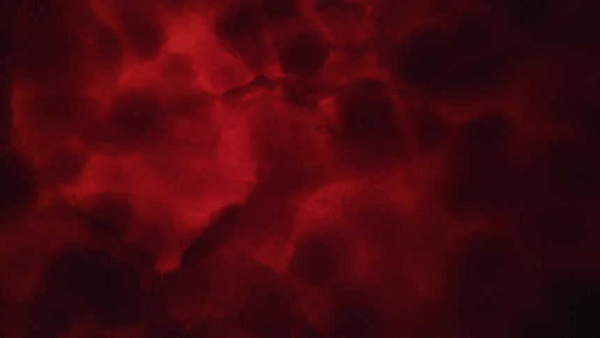 Flowing red liquid in the dark