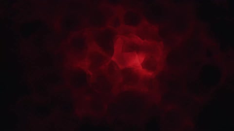 Bubbling red liquid in the dark