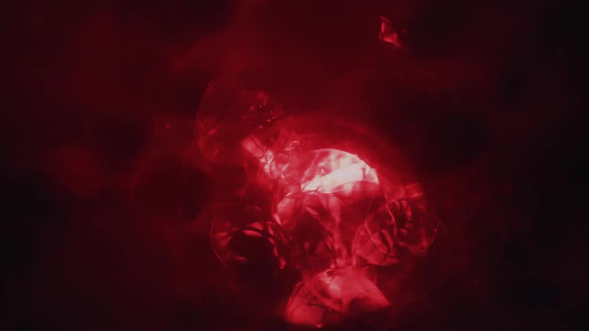 A red color moves and forms diamond patterns on a black screen
