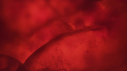 Pulsating red cloth waving in a back light tank
