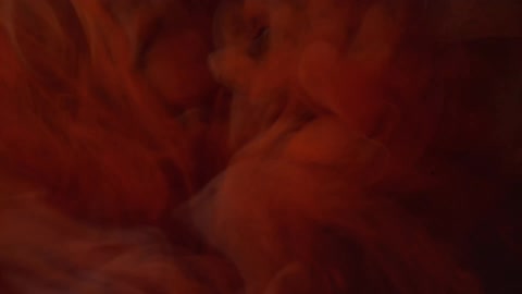 Swirling red liquid in the dark