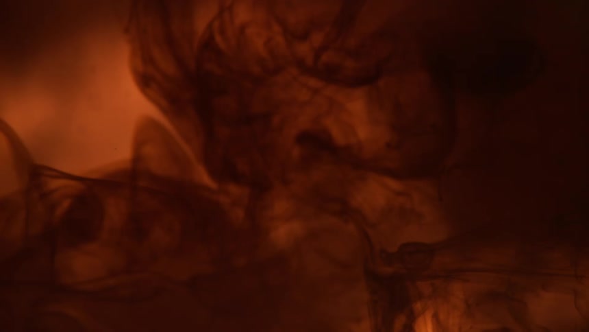Light and shadow dance over surface of orange and amber colored textured area
