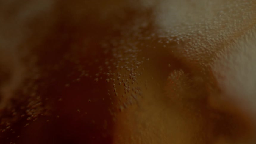 Liquid being incorporated into another material with movement and bubbles