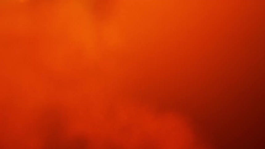 Red and orange colors swirl and blend lit from within