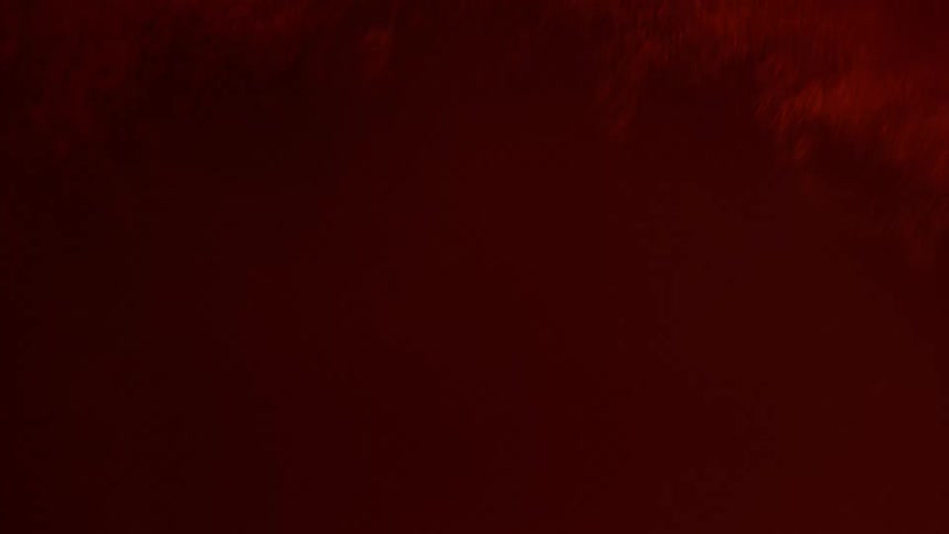An explosion of liquid and bubbles in a red orange liquid