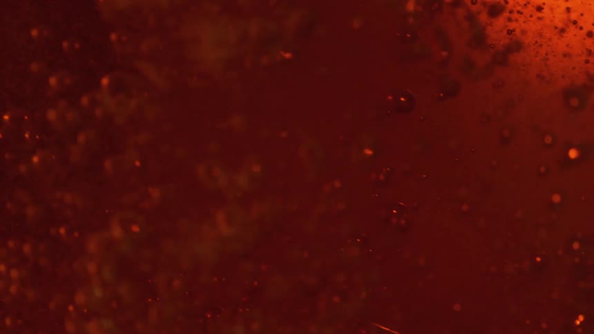 Bubbles flowing in amber liquid