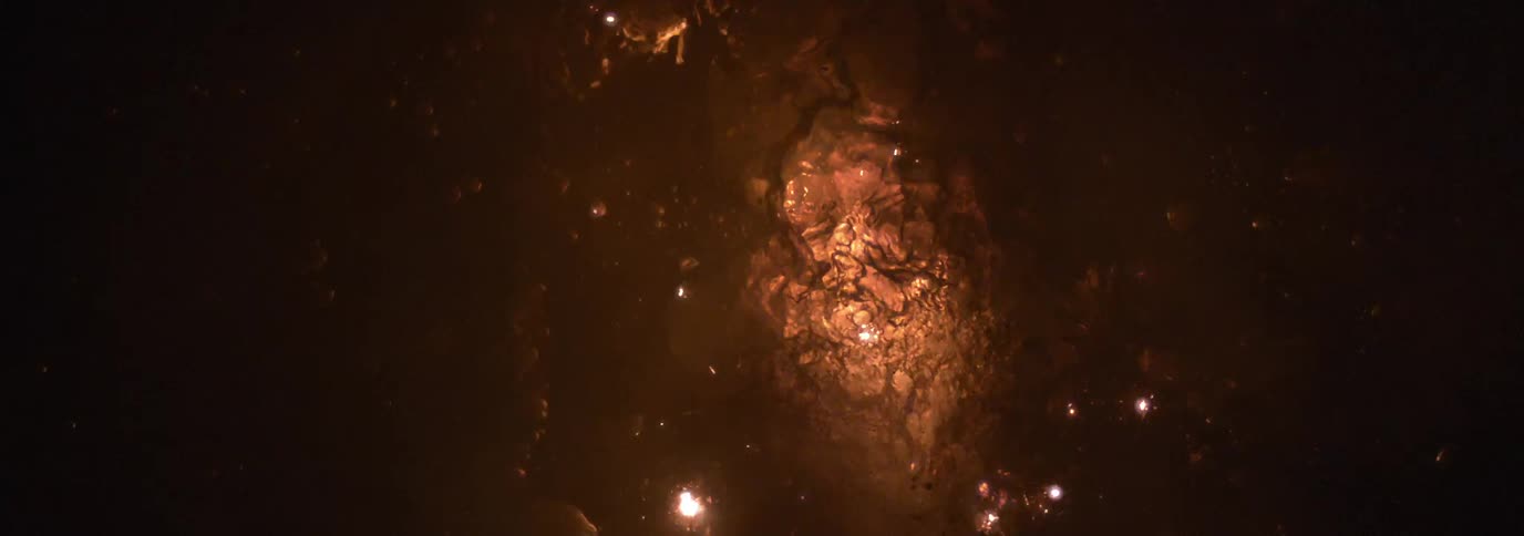 Sparks fly and explode in a liquid to create a fire effect