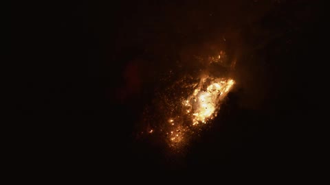 Firework or torch shooting sparks underwater on a dark room