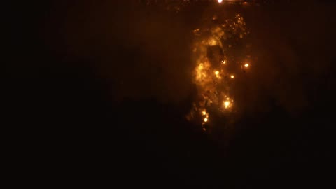 Sparks burning underwater in the dark