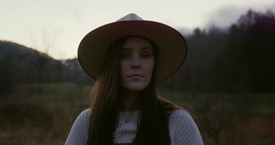 A young woman standing in field