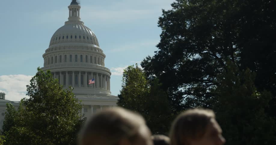 People walking past a government building