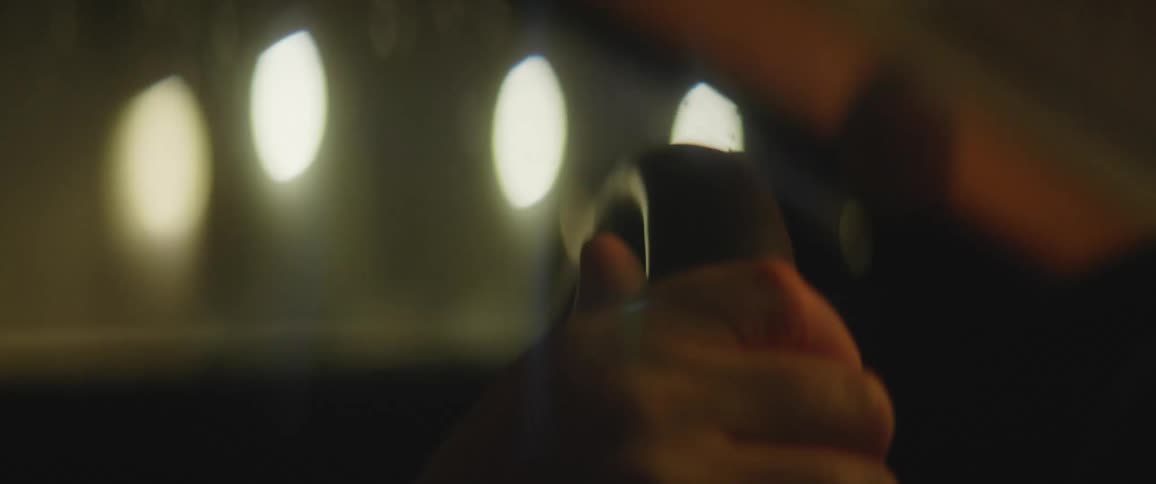 Mans hand holds the steering wheel to make the vehicle go in a particular direction