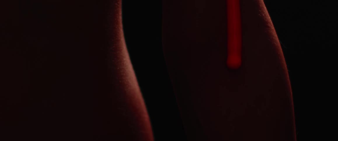 A viscous red liquid drips down the side of an hourglass shape