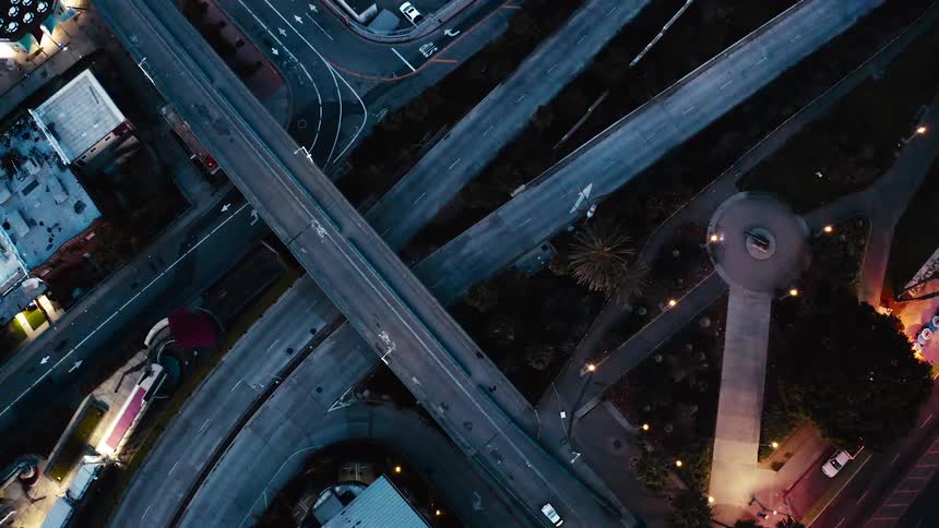 Birds eye view of roads in a city with cars driving on them
