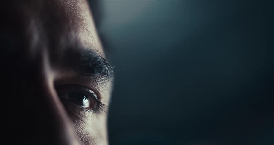 A man is standing in a room at night