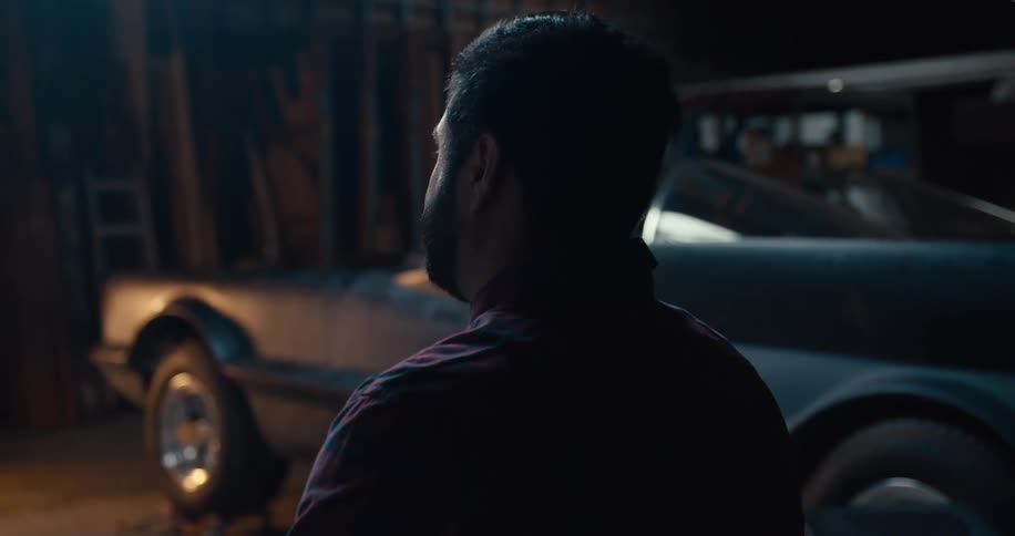 A man stands in next to a car