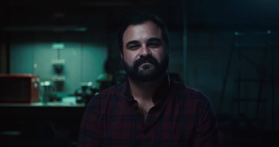 A man is standing in a room at night