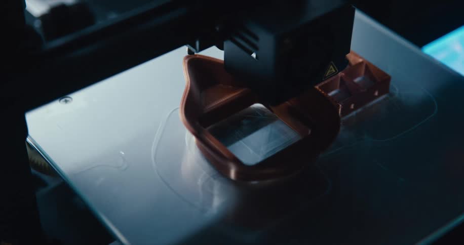 A 3d printer printing a piece of plastic