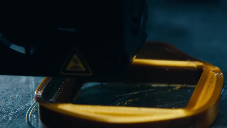 A 3d printer printing a piece of plastic
