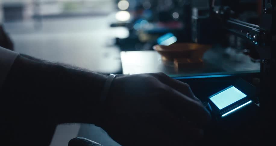 Man selecting something on screen of 3d printer