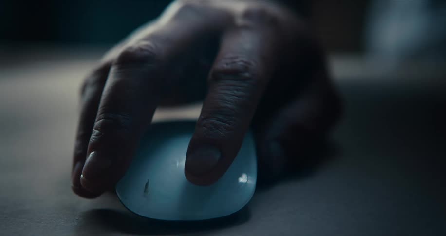 A man moves and clicks on a computer mouse