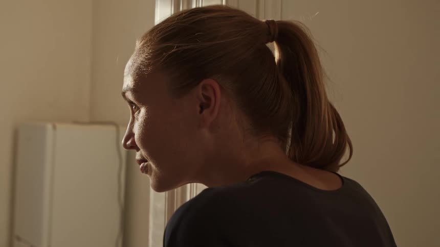 A woman is walking into a room