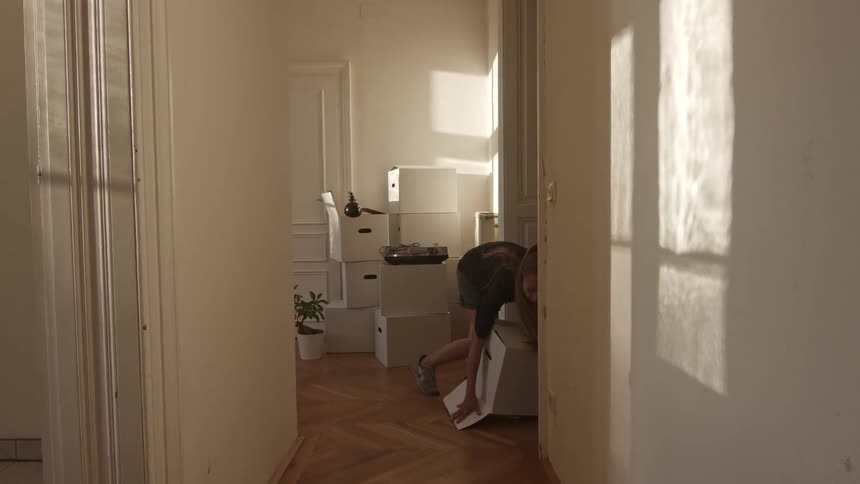 A woman carried a box that opened on the bottom