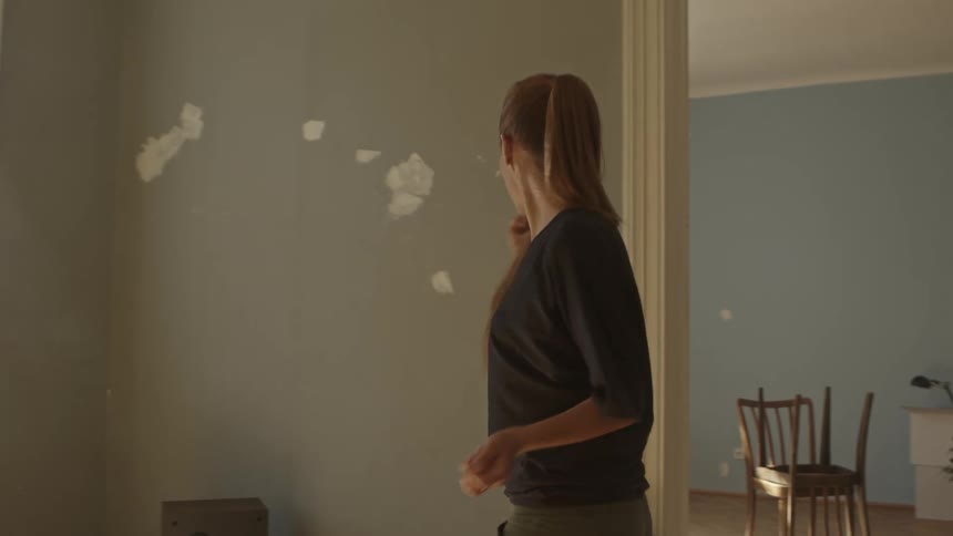 A young woman dancing in her house