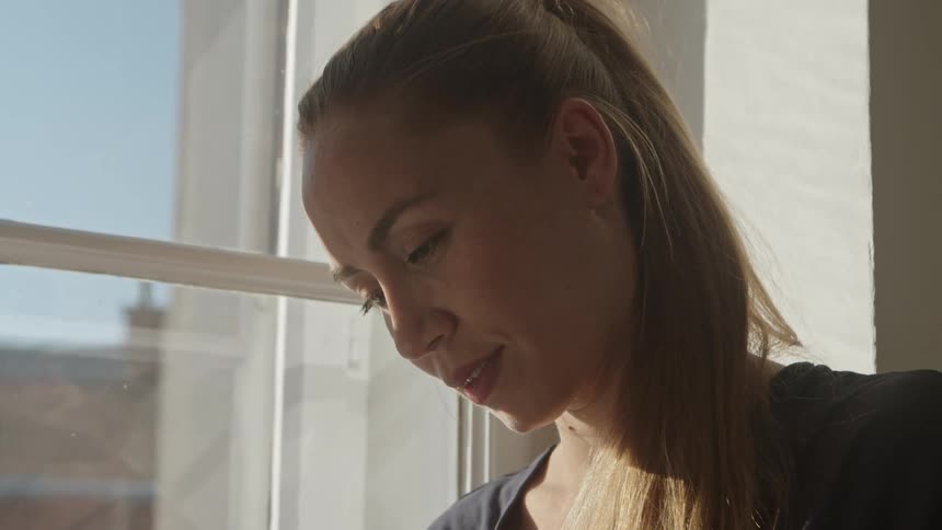 A woman is smiling indoors during the day