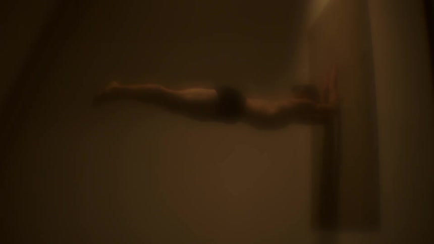 A man is doing a hand stand on the mat