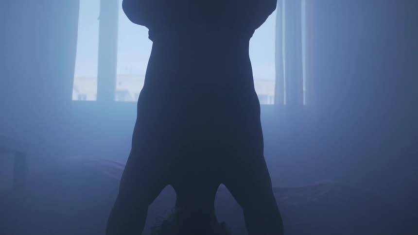 A woman doing a headstand at home