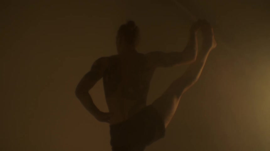 A man at home stretches as he exercises