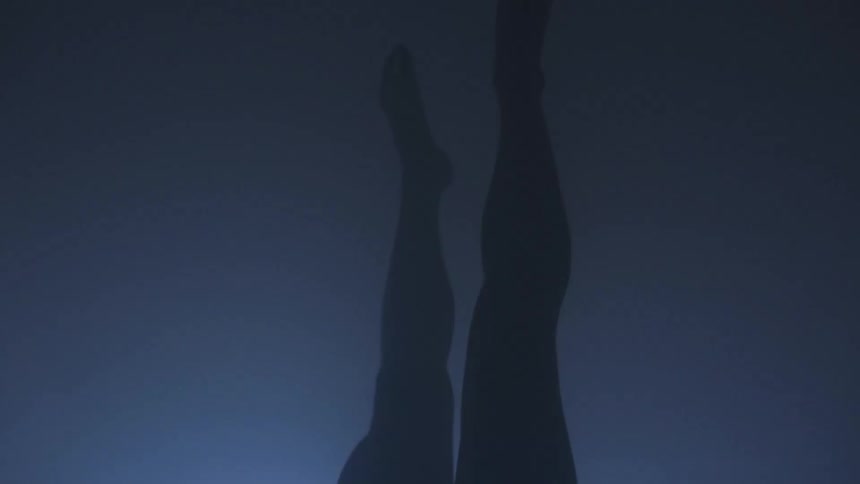 A man moves his legs up to complete a handstand