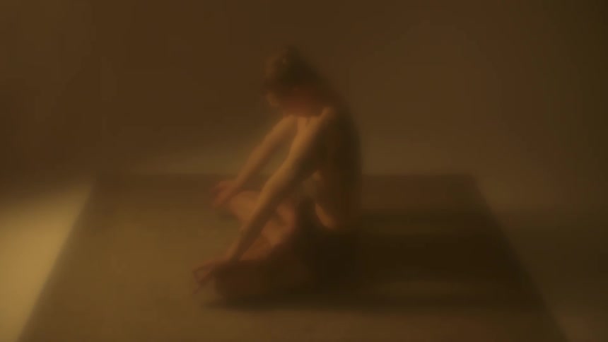 A young woman stretches as she exercises