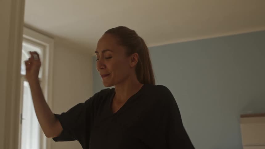 A woman dancing around her house