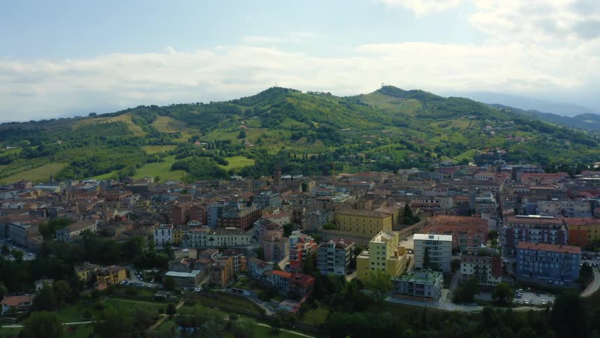 Aerial view of colorful buildings in a small town on the green hills