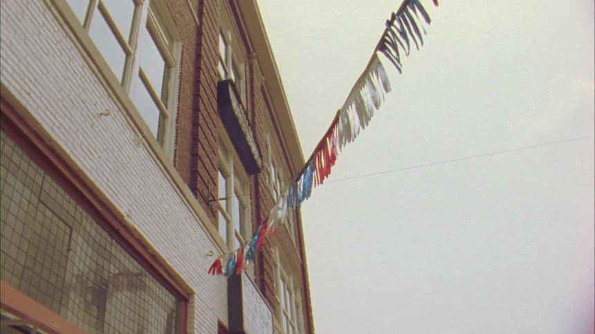 A view of the brickhouse saloons exterior with party streamers going from the building to a light post