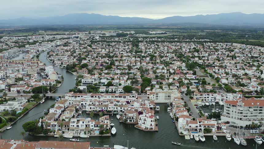 A city with canals and boats with the sky and clouds in the background