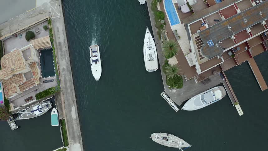 A marina with boats buildings trees and grass