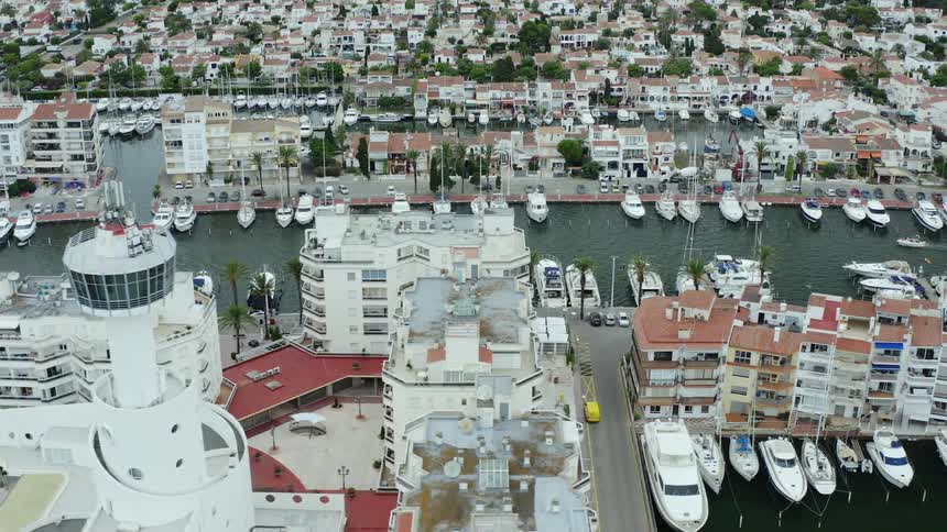 City and homes with a body of water with ports and boats