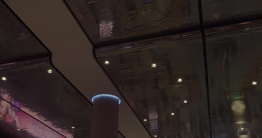 The metal ceiling reflects a person walking below