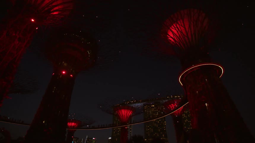 An art structure of lights displays change color from red to green and smaller sets of twinkling white lights come on and off at night time
